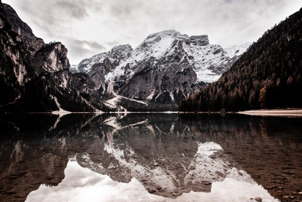 amazing lake and high mountains in snow in Italy